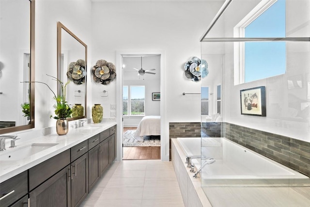 6020 Sendero Hills Pkwy, Austin, TX 78724 - full bath with a bath, double vanity, ceiling fan, connected bathroom, and tile patterned flooring