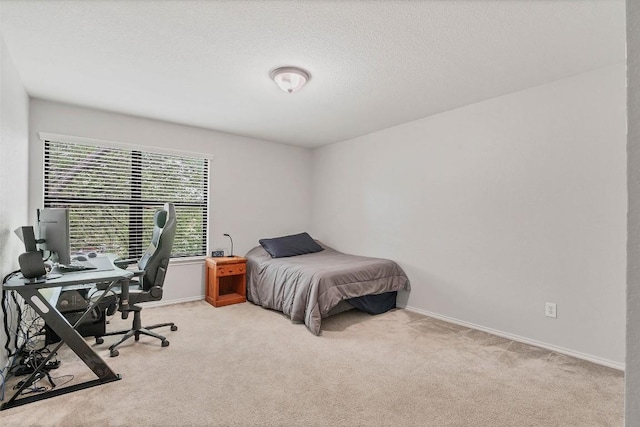 carpeted bedroom featuring baseboards