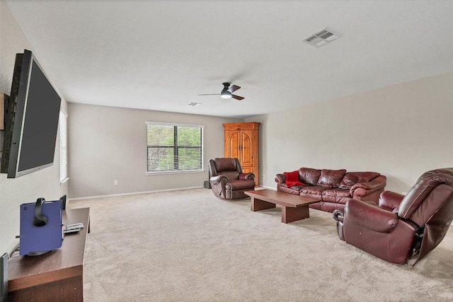 carpeted living area featuring baseboards, visible vents, and ceiling fan
