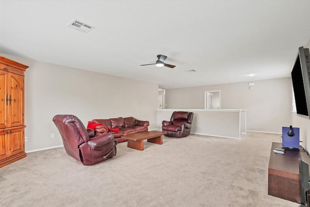 living area with ceiling fan, visible vents, baseboards, and light carpet