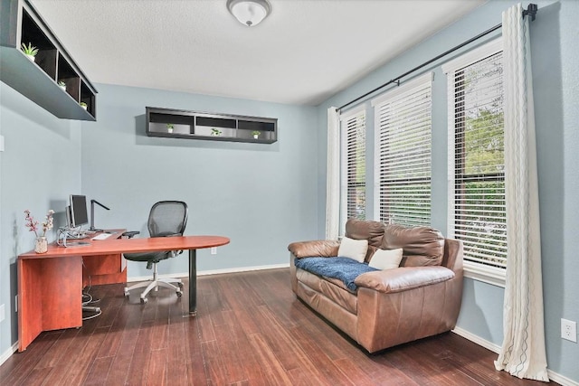 office space featuring baseboards and wood finished floors