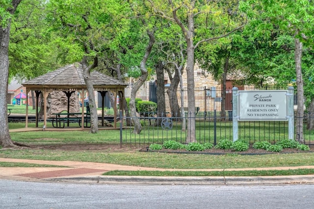 view of home's community featuring a lawn, a gazebo, and fence