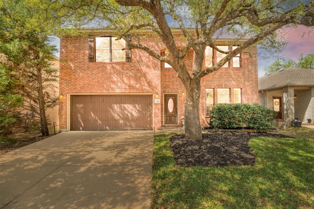traditional home featuring a garage, driveway, and brick siding
