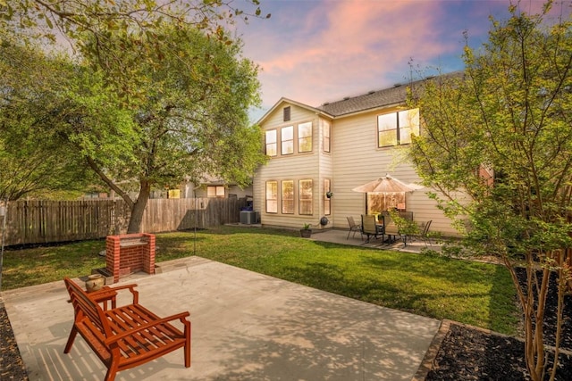 rear view of property featuring a patio area, central AC, and fence