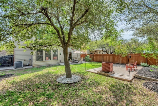 view of yard featuring a patio area, a fenced backyard, a wooden deck, and central AC