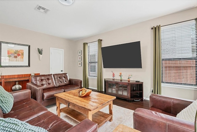 living room with visible vents and wood finished floors