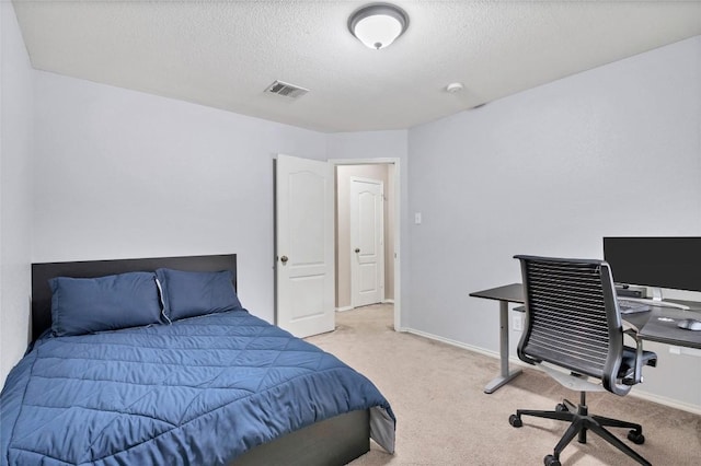 bedroom featuring a textured ceiling, visible vents, carpet flooring, and baseboards