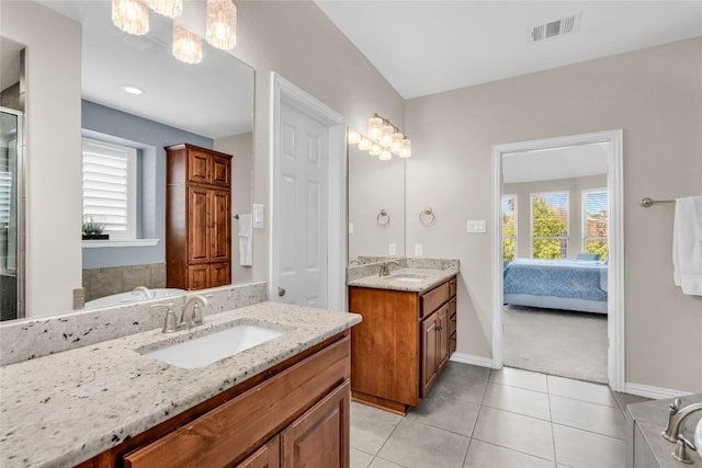 3925 Good Night Trl, Leander, TX 78641 - bathroom featuring two vanities, ensuite bath, tile patterned flooring, and a shower stall