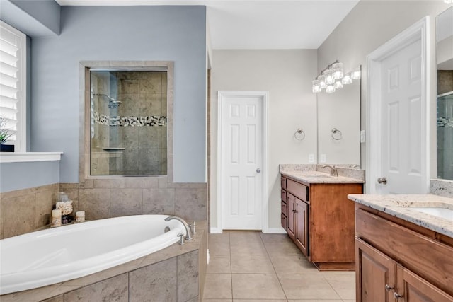 3925 Good Night Trl, Leander, TX 78641 - full bathroom with two vanities, a stall shower, a bath, and tile patterned floors