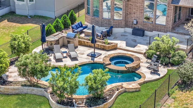 3925 Good Night Trl, Leander, TX 78641 - view of swimming pool featuring exterior kitchen, a patio, a fenced backyard, a pool with connected hot tub, and outdoor lounge area