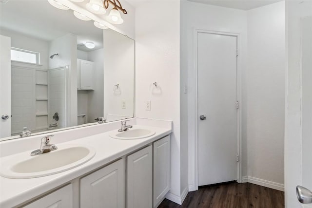 804 Lavaca Loop, Elgin, TX 78621 - bathroom featuring double vanity, wood finished floors, and bathing tub / shower combination