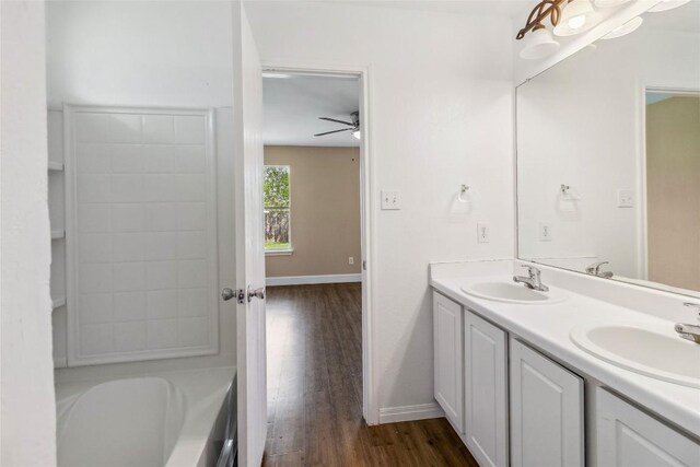 804 Lavaca Loop, Elgin, TX 78621 - full bath with double vanity, wood finished floors, and ceiling fan