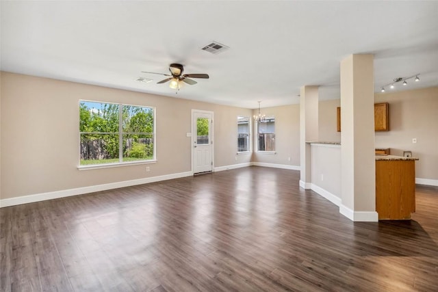 804 Lavaca Loop, Elgin, TX 78621 - unfurnished living room with a ceiling fan, a chandelier, and dark wood-type flooring