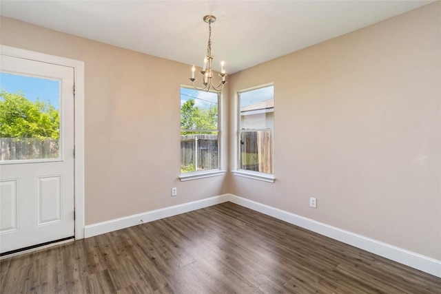 804 Lavaca Loop, Elgin, TX 78621 - unfurnished dining area featuring a chandelier and wood finished floors