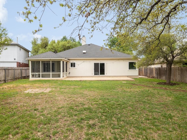 8004 Osborne Dr, Austin, TX 78729 - rear view of house with a sunroom, a patio, and a chimney