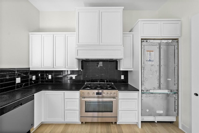 3306 Larry Ln Unit B, Austin, TX 78722 - kitchen with appliances with stainless steel finishes, dark countertops, white cabinetry, and light wood-style flooring