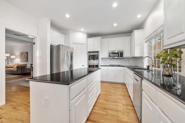 5204 Eagle Trace Trl, Austin, TX 78730 - kitchen featuring stainless steel appliances, a sink, light wood finished floors, white cabinets, and recessed lighting
