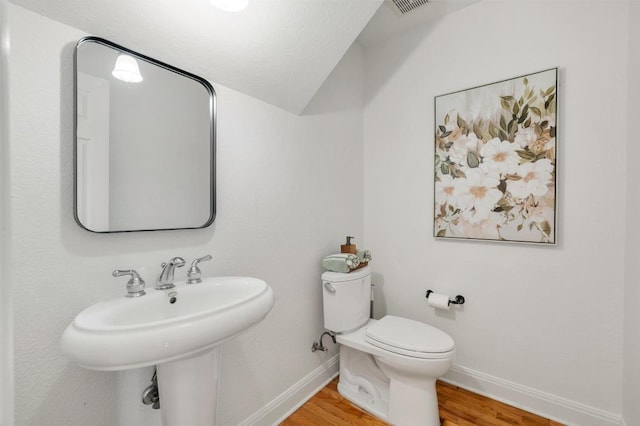 5204 Eagle Trace Trl, Austin, TX 78730 - bathroom featuring baseboards, lofted ceiling, toilet, and wood finished floors