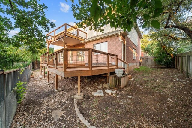 5204 Eagle Trace Trl, Austin, TX 78730 - back of property with brick siding, a fenced backyard, a wooden deck, and a balcony