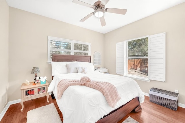 3028 Indigo Trl, Round Rock, TX 78665 - bedroom with multiple windows, baseboards, wood finished floors, and ceiling fan