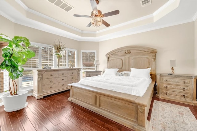 3028 Indigo Trl, Round Rock, TX 78665 - bedroom featuring a tray ceiling, crown molding, dark wood-style floors, and a ceiling fan