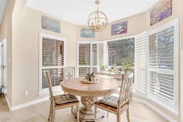 3028 Indigo Trl, Round Rock, TX 78665 - dining area featuring a chandelier, light marble finish floors, and baseboards