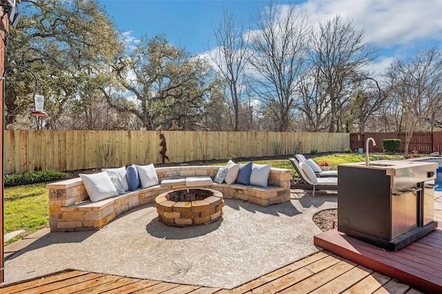 3028 Indigo Trl, Round Rock, TX 78665 - fenced backyard with a fire pit, a deck, a sink, and a patio