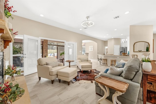 3028 Indigo Trl, Round Rock, TX 78665 - living area featuring arched walkways, recessed lighting, and light marble finish floors