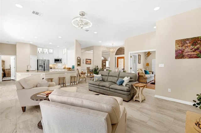 3028 Indigo Trl, Round Rock, TX 78665 - living room with a chandelier, recessed lighting, light marble finish floors, and baseboards