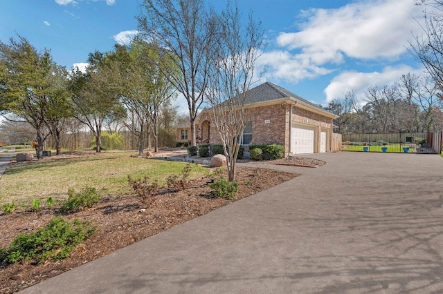 3028 Indigo Trl, Round Rock, TX 78665 - view of side of home featuring brick siding, an attached garage, and driveway