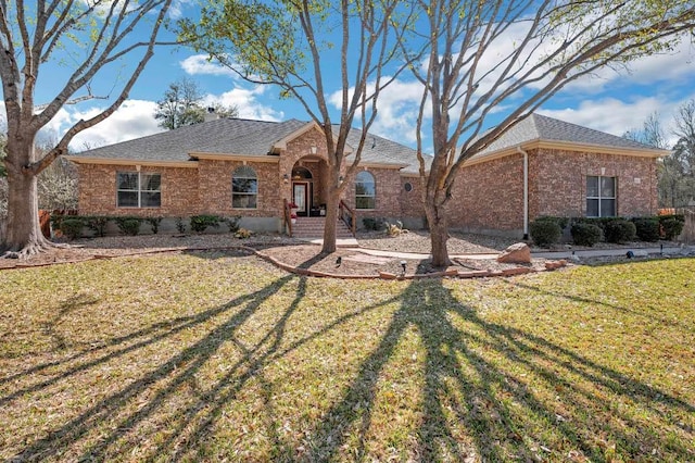 3028 Indigo Trl, Round Rock, TX 78665 - single story home with a front lawn, brick siding, and a shingled roof