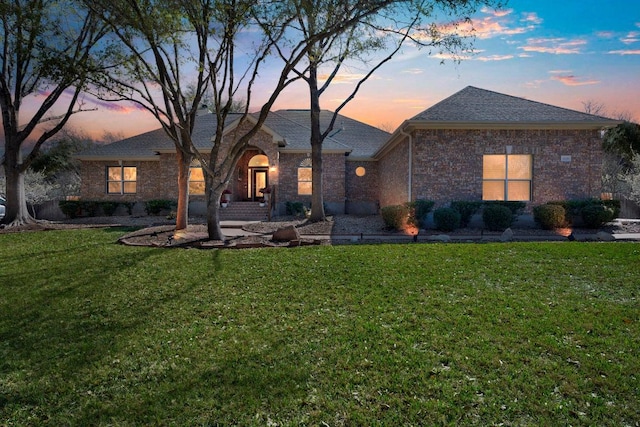 3028 Indigo Trl, Round Rock, TX 78665 - view of front of home with a front lawn, brick siding, and a shingled roof