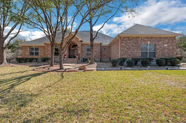 3028 Indigo Trl, Round Rock, TX 78665 - ranch-style house featuring a front yard, brick siding, and a shingled roof