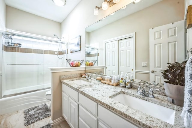 3028 Indigo Trl, Round Rock, TX 78665 - bathroom featuring shower / bath combination with glass door, double vanity, and toilet