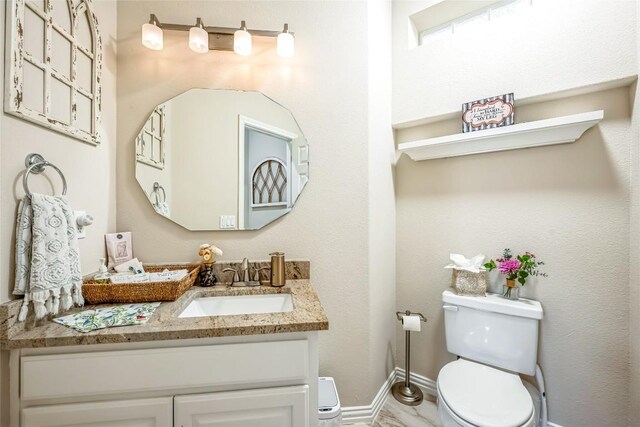 3028 Indigo Trl, Round Rock, TX 78665 - bathroom with toilet, vanity, and baseboards
