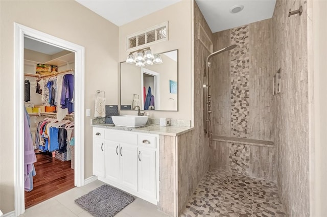 3028 Indigo Trl, Round Rock, TX 78665 - full bath with a tile shower, vanity, a walk in closet, and tile patterned floors