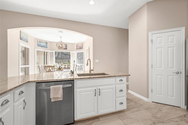 3028 Indigo Trl, Round Rock, TX 78665 - kitchen with dishwasher, a sink, arched walkways, light stone counters, and white cabinetry