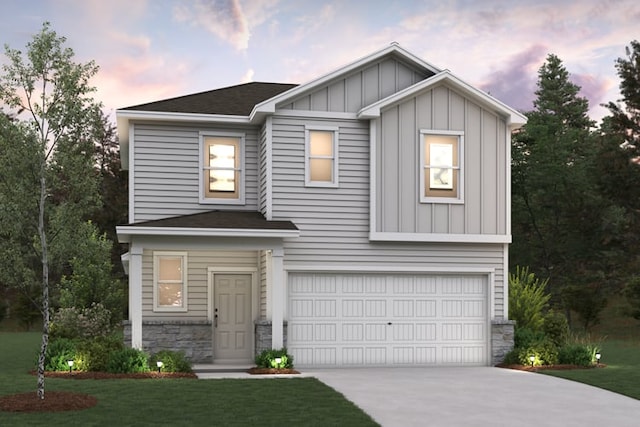 204 Escape Way, Jarrell, TX 76537 - view of front facade featuring an attached garage, driveway, stone siding, board and batten siding, and a lawn