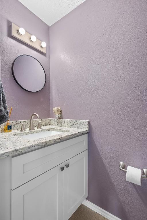 bathroom with vanity and baseboards