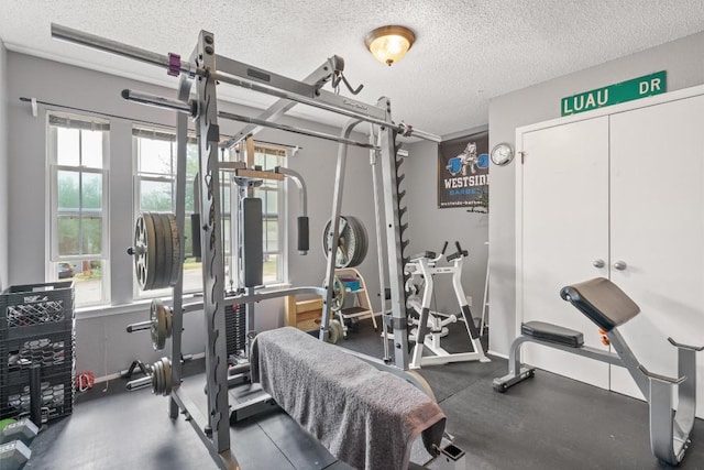 workout area featuring a textured ceiling