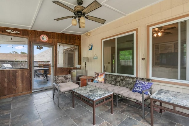 sunroom / solarium with a ceiling fan