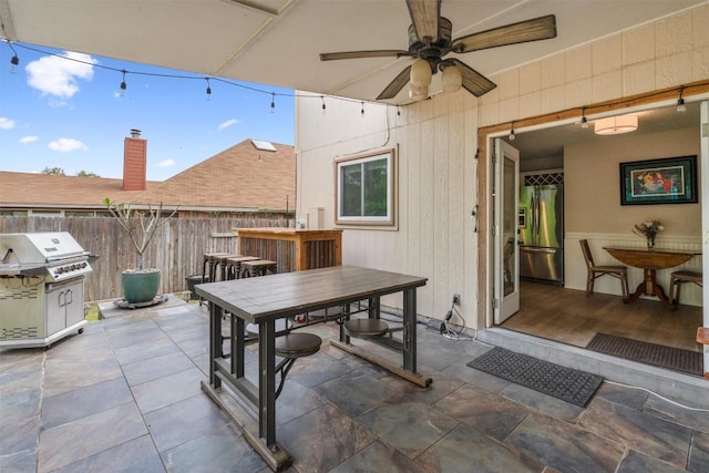 view of patio / terrace with ceiling fan, fence, outdoor dining space, and grilling area