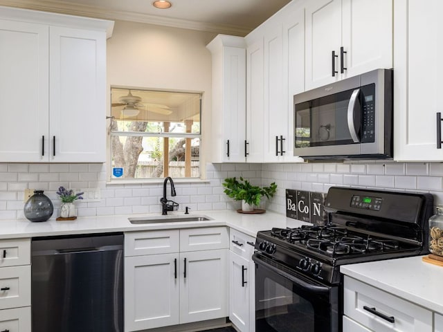 8001 Rimini Trl, Austin, TX 78729 - kitchen with stainless steel microwave, black range with gas cooktop, dishwasher, a sink, and ornamental molding