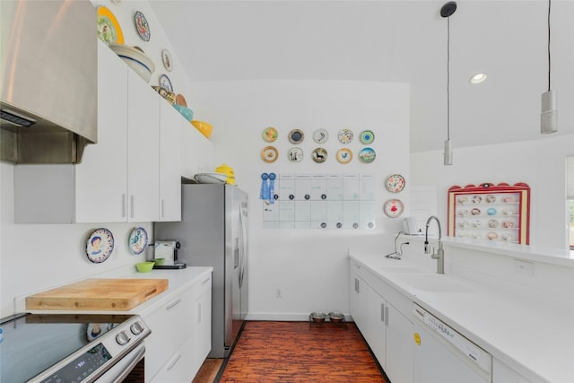 kitchen featuring appliances with stainless steel finishes, a sink, light countertops, white cabinets, and recessed lighting