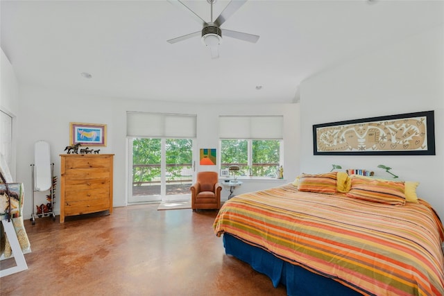 bedroom featuring access to outside, a ceiling fan, and finished concrete floors
