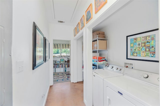 laundry area featuring washing machine and clothes dryer, baseboards, visible vents, and attic access