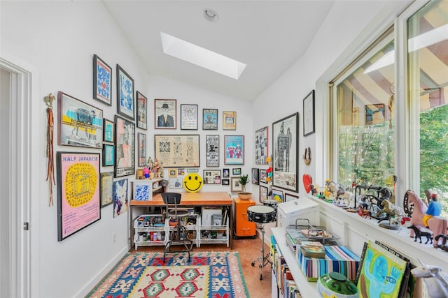 game room with vaulted ceiling with skylight