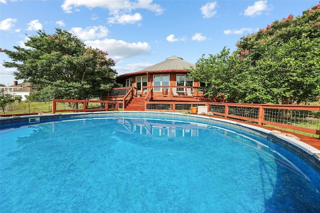 view of pool featuring a fenced in pool, a wooden deck, and fence