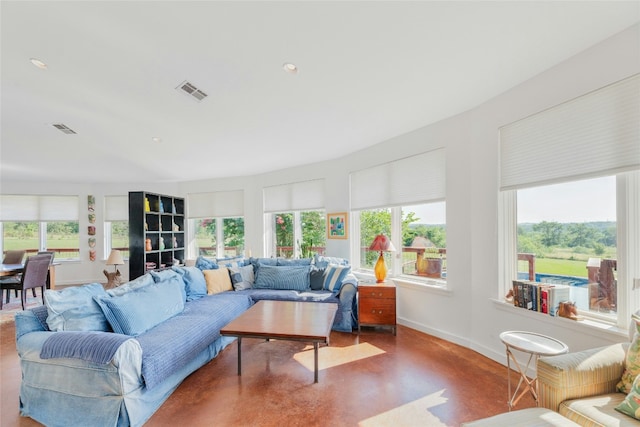 living area with recessed lighting, baseboards, visible vents, and finished concrete floors