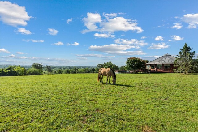 view of yard featuring a rural view and a wooden deck